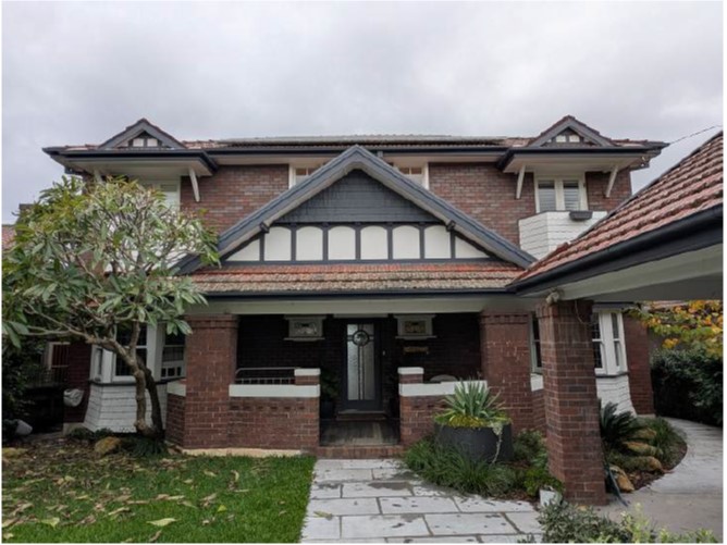 A brick house with a walkway and a tree
AI-generated content may be incorrect.