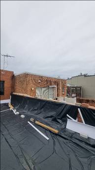 A building with a window and a black tarp

AI-generated content may be incorrect.