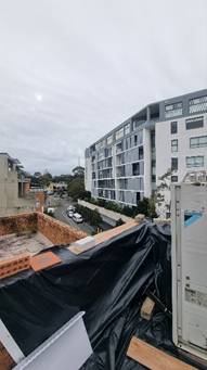 A building with a tarp on the roof

AI-generated content may be incorrect.