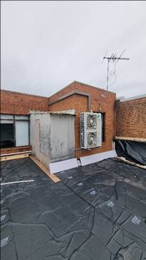 A brick building with a window and a door

AI-generated content may be incorrect.