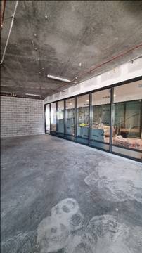 A room with a brick wall and glass windows

AI-generated content may be incorrect.