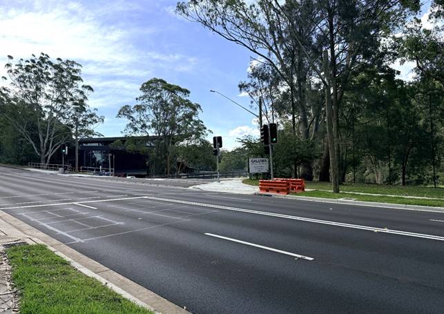 A road with trees and a building

AI-generated content may be incorrect.