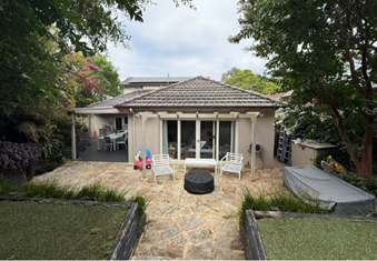 A house with a patio and trees

AI-generated content may be incorrect.