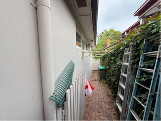 A white wall with a white fence and a white fence

AI-generated content may be incorrect.