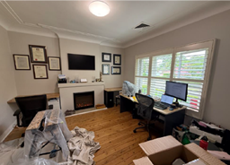 A room with a fireplace and a computer

AI-generated content may be incorrect.