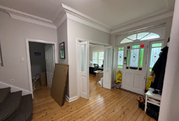 A room with a wood floor and a door

AI-generated content may be incorrect.