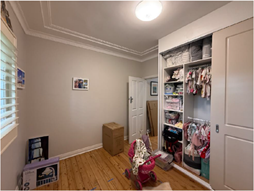 A room with a closet full of clothes

AI-generated content may be incorrect.