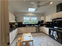 A kitchen with a table and chairs

AI-generated content may be incorrect.