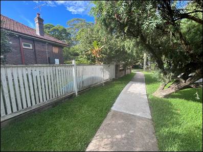 A path with a fence and grass and trees

AI-generated content may be incorrect.