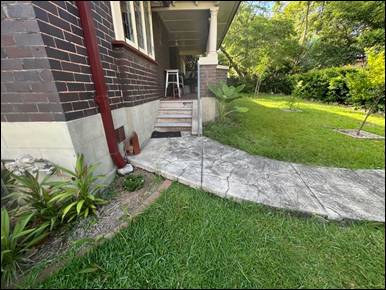 A walkway leading to a house

AI-generated content may be incorrect.