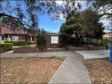 A brick house with a fence and trees

AI-generated content may be incorrect.