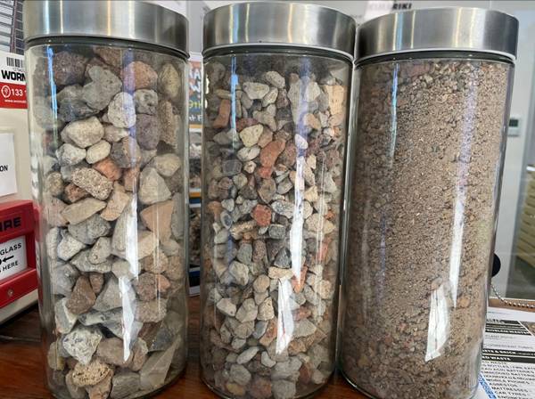 A group of glass containers with rocks in them